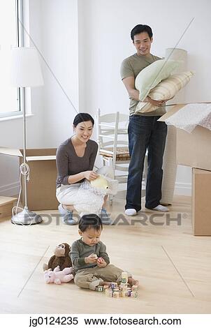 Asian parents watching baby play with blocks on floor View Large Photo Image Stock Photography - Asian parents watching baby play with blocks on floor. Fotosearch