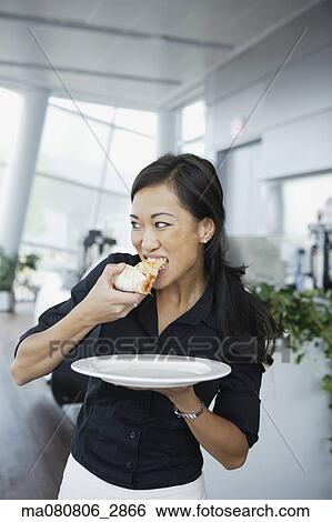 Asian woman eating pizza View Large Photo Image Stock Photograph - Asian woman eating pizza. Fotosearch