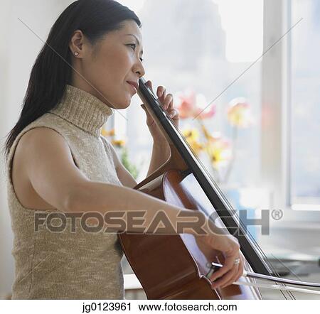 Asian woman playing cello View Large Photo Image Stock Image - Asian woman playing cello. Fotosearch
