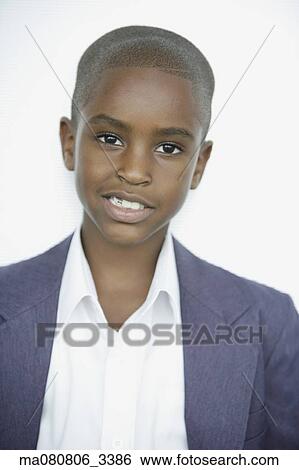 Stock Photograph - Close up of African boy in suit jacket. Fotosearch