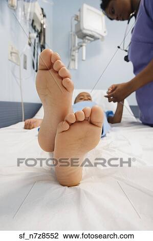 Close up of African boy’s bare feet in hospital bed View Large Photo Image Stock Image - Close up of African boy’s bare feet in hospital bed. Fotosearch