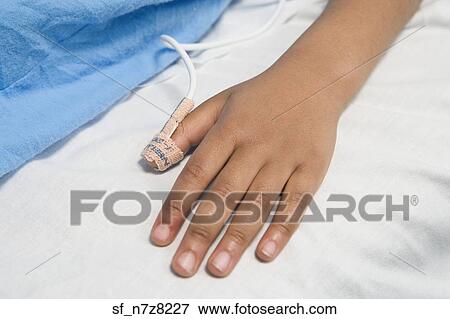 Close up of African child’s hand with IV on hospital bed View Large Photo Image Stock Photo - Close up of African child’s hand with IV on hospital bed. Fotosearch