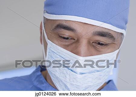 Stock Photograph - Close up of African male doctor with surgical mask . Fotosearch