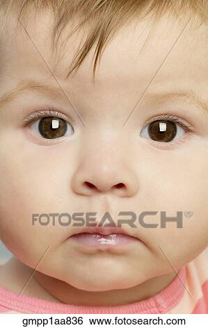 Stock Photograph - Close up of baby’s face. Fotosearch