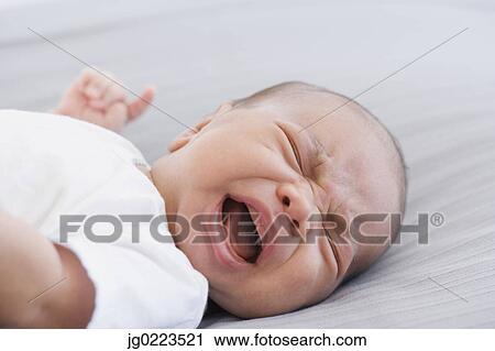 Close up of crying newborn baby View Large Photo Image Stock Image - Close up of crying newborn baby. Fotosearch