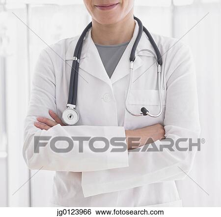 Close up of female doctor with arms crossed View Large Photo Image Stock Photograph - Close up of female doctor with arms crossed. Fotosearch