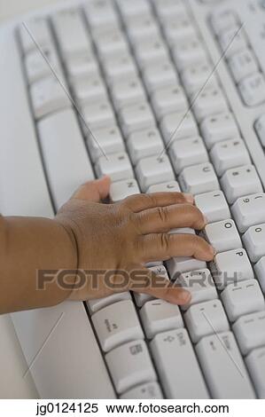 Close up of Hispanic baby’s hand on computer keyboard View Large Photo Image Stock Photography - Close up of Hispanic baby’s hand on computer keyboard. Fotosearch
