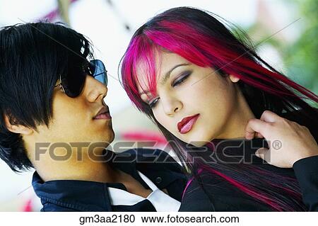 Stock Image - Close up of Hispanic punk couple outdoors. Fotosearch