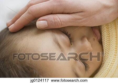 Close up of Hispanic sleeping baby with mother’s hand on cheek View Large Photo Image Stock Photo - Close up of Hispanic sleeping baby with mother’s hand on cheek. Fotosearch