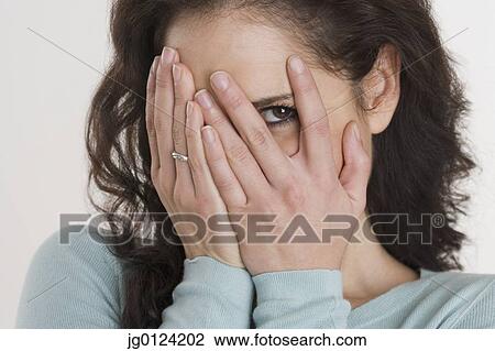 Close up of Hispanic woman peeking through fingers View Large Photo Image Stock Image - Close up of Hispanic woman peeking through fingers. Fotosearch