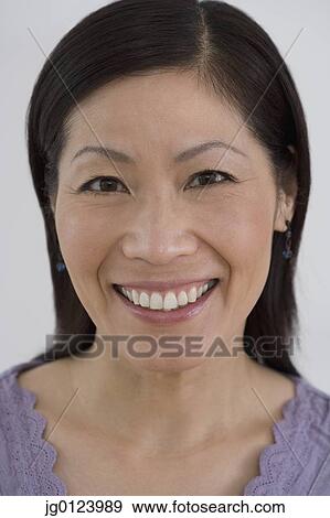 Stock Photo - Close up of middle-aged Asian woman smiling. Fotosearch
