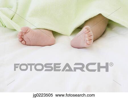 Stock Photography - Close up of newborn baby’s feet. Fotosearch