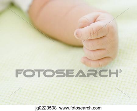 Stock Photo - Close up of newborn baby’s hand. Fotosearch