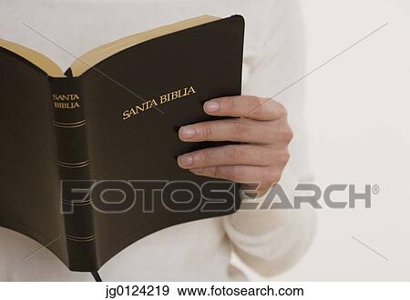 Stock Photo - Close up of person reading bible. Fotosearch