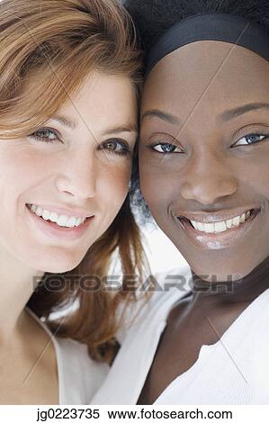 Close up of two women smiling View Large Photo Image Stock Photography - Close up of two women smiling. Fotosearch