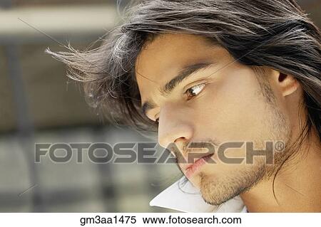 Stock Photography - Close up of young Hispanic man looking down. Fotosearch