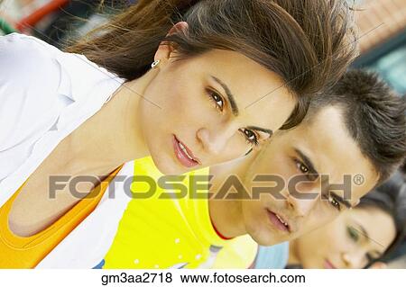 Close up of young Hispanic woman and man outdoors View Large Photo Image Stock Photo - Close up of young Hispanic woman and man outdoors. Fotosearch