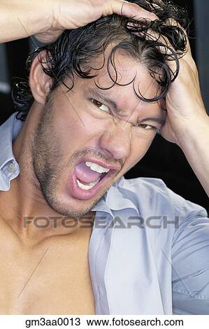 Close up of young man yelling with hands on head View Large Photo Image Stock Image - Close up of young man yelling with hands on head. Fotosearch
