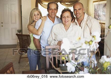 Stock Photograph - Family with adult children in posing livingroom. Fotosearch