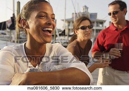 Friends having drinks at marina View Large Photo Image Stock Image - Friends having drinks at marina. Fotosearch