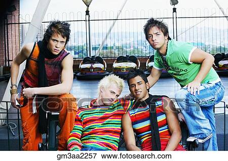 Group of teenage boys sitting on bench near bumper cars View Large Photo Image Stock Photo - Group of teenage boys sitting on bench near bumper cars. Fotosearch