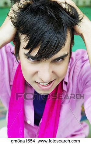 High angle view of young Hispanic man with hands in hair View Large Photo Image Picture - High angle view of young Hispanic man with hands in hair. Fotosearch