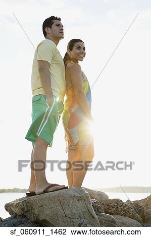Hispanic couple standing on rocks at beach View Large Photo Image Stock Image - Hispanic couple standing on rocks at beach. Fotosearch