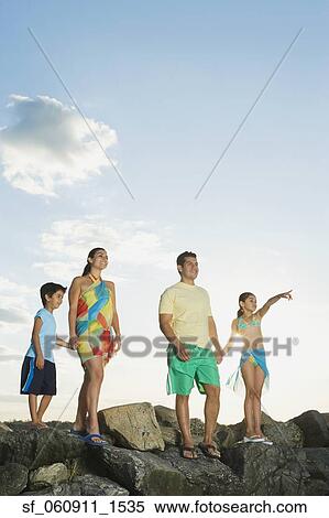 Hispanic family standing on rocks at beach View Large Photo Image Stock Photography - Hispanic family standing on rocks at beach. Fotosearch