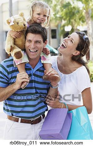 Hispanic family walking with shopping bags outdoors View Large Photo Image Stock Image - Hispanic family walking with shopping bags outdoors. Fotosearch