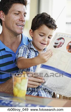 Hispanic father and son reading menu at restaurant View Large Photo Image Stock Photo - Hispanic father and son reading menu at restaurant. Fotosearch