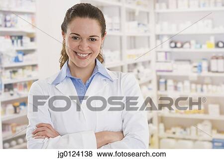 Hispanic female pharmacist smiling in pharmacy View Large Photo Image Stock Photo - Hispanic female pharmacist smiling in pharmacy. Fotosearch