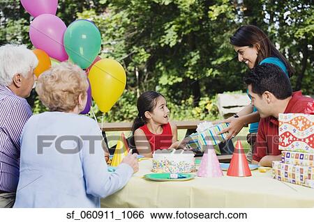 Hispanic girl receiving gifts at birthday party View Large Photo Image Stock Photograph - Hispanic girl receiving gifts at birthday party. Fotosearch