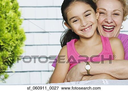 Hispanic grandmother and granddaughter hugging View Large Photo Image Stock Photo - Hispanic grandmother and granddaughter hugging. Fotosearch
