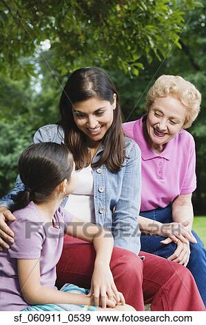 Hispanic grandmother, mother and daughter sitting together View Large Photo Image Stock Photo - Hispanic grandmother, mother and daughter sitting together. Fotosearch
