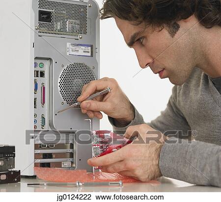 Hispanic man fixing computer View Large Photo Image Stock Image - Hispanic man fixing computer. Fotosearch