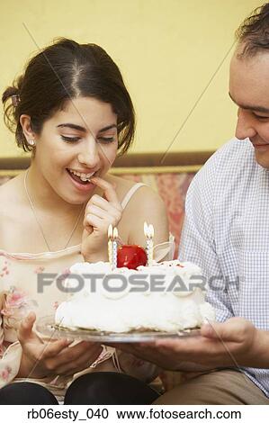 Hispanic man giving girlfriend birthday cake View Large Photo Image Stock Image - Hispanic man giving girlfriend birthday cake. Fotosearch