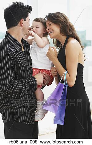 Hispanic parents holding daughter View Large Photo Image Stock Photo - Hispanic parents holding daughter. Fotosearch