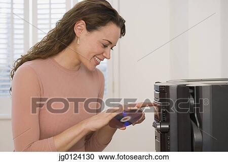 Hispanic woman putting cd into stereo View Large Photo Image Stock Image - Hispanic woman putting cd into stereo. Fotosearch