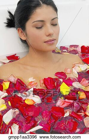 Hispanic woman with eyes closed in bath of flower petals View Large Photo Image Stock Photograph - Hispanic woman with eyes closed in bath of flower petals. Fotosearch
