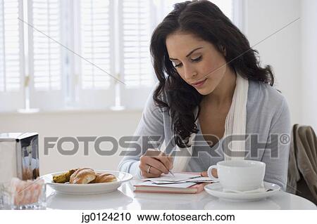 Hispanic woman writing letter in cafe View Large Photo Image Stock Image - Hispanic woman writing letter in cafe. Fotosearch