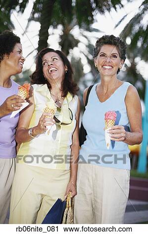 Hispanic women eating ice cream cones View Large Photo Image Stock Image - Hispanic women eating ice cream cones. Fotosearch