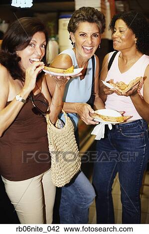 Hispanic women eating pizza View Large Photo Image Stock Image - Hispanic women eating pizza. Fotosearch