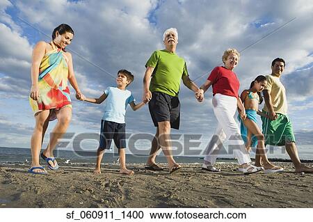 Low angle view of Hispanic family holding hands at beach View Large Photo Image Stock Image - Low angle view of Hispanic family holding hands at beach. Fotosearch