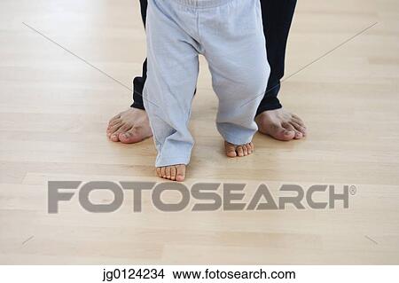 Low section of barefoot baby and father View Large Photo Image Picture - Low section of barefoot baby and father. Fotosearch