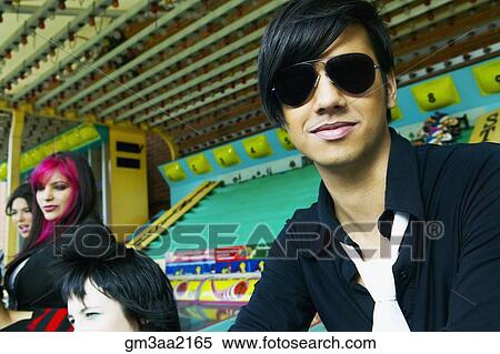 Punk Hispanic teenager sitting with friends in carnival booth View Large Photo Image Stock Photography - Punk Hispanic teenager sitting with friends in carnival booth. Fotosearch