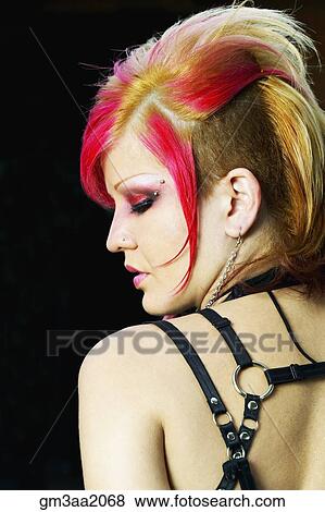Stock Photo - Rear view of young Hispanic woman with punk hair and clothing. Fotosearch