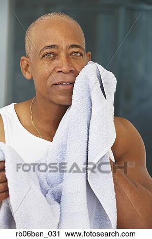 Senior African man drying face with towel View Large Photo Image Stock Image - Senior African man drying face with towel. Fotosearch