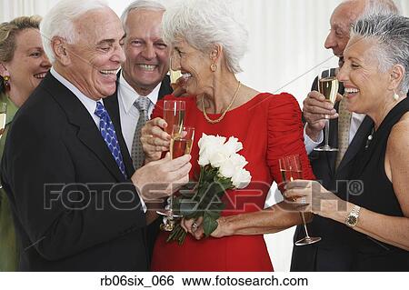 Senior friends drinking champagne at party View Large Photo Image Stock Photograph - Senior friends drinking champagne at party. Fotosearch