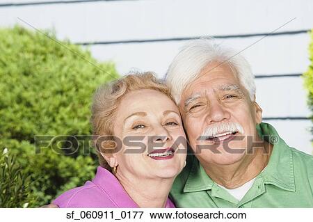 Senior Hispanic couple hugging outdoors View Large Photo Image Stock Photo - Senior Hispanic couple hugging outdoors. Fotosearch