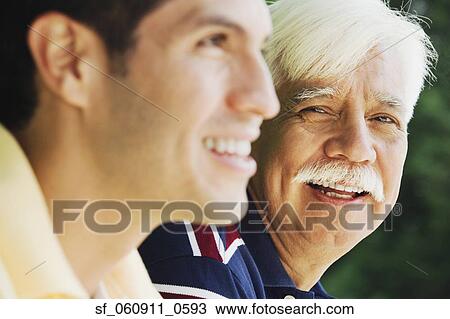 Stock Image - Senior Hispanic man with adult son. Fotosearch